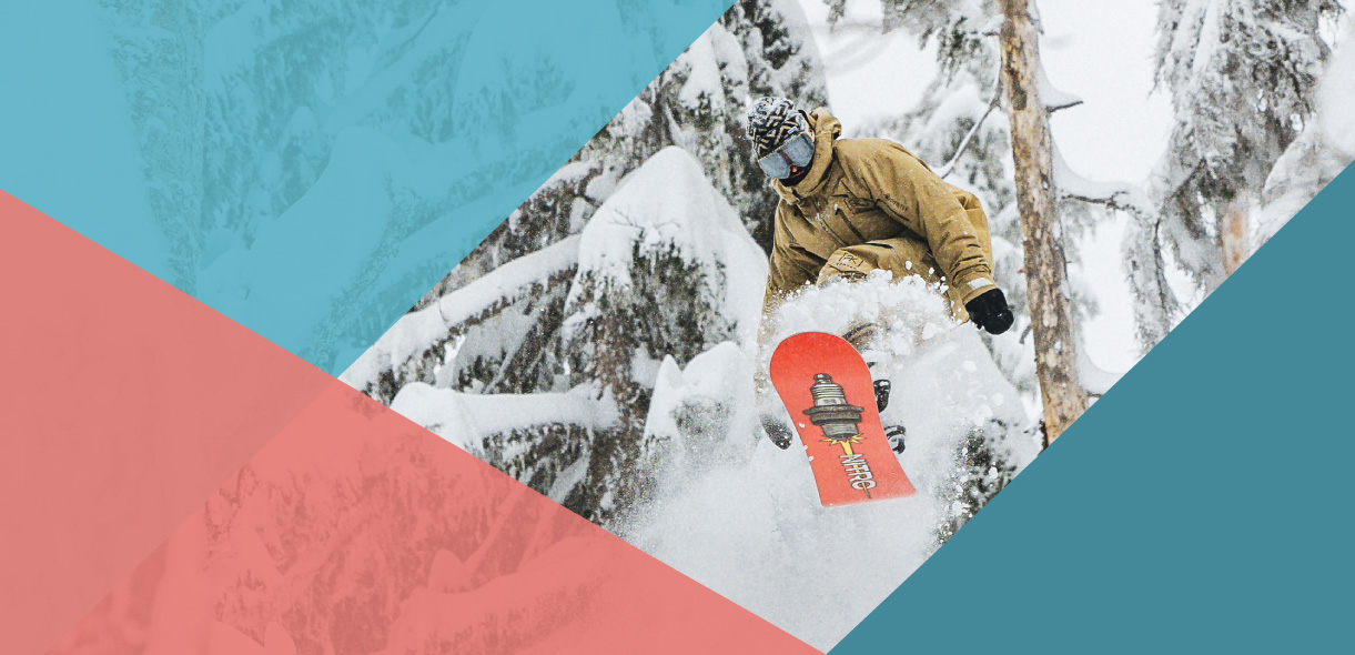 Snowboarder in a khaki coat on a red board doing a toeside grab in powder